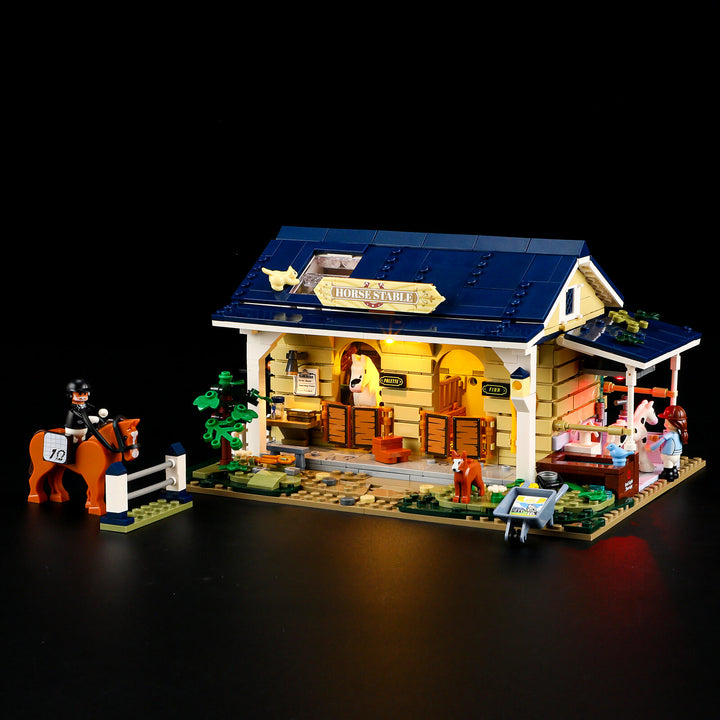 Interior view of Lumibricks Horse Stable F9080 featuring a rider minifigure, a horse, fences, and accessories like a water bucket.